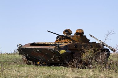 Burned infantry fighting vehicle near the Saur-Grave clipart