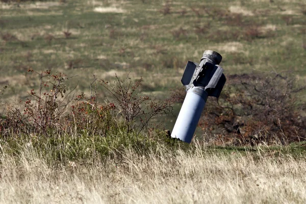 Dud multiple rocket launchers Hurricane sticking in the steppe — Stock Photo, Image