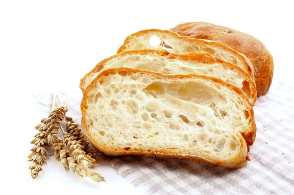 Fresh baguette bread and ripe ears of wheat — Stock Photo, Image