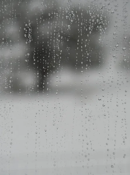 Raindrops on a window pane in the rain in Greece