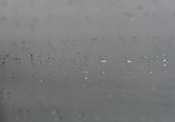 Raindrops on a window pane in the rain in Greece