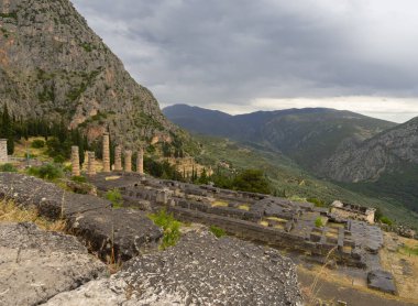Panoramic view on Temple of Apollo  in Delphi against the background sky with clouds in Greece