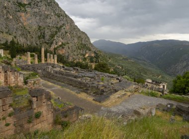 Panoramic view on Temple of Apollo  in Delphi against the background sky with clouds in Greece