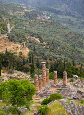 Panoramic view on Temple of Apollo  in Delphi against the background sky with clouds in Greece