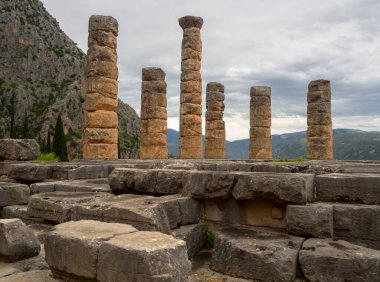 Panoramic view on Temple of Apollo  in Delphi against the background sky with clouds in Greece