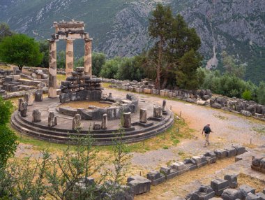 Panoramic view on Temple Athena Pronaia among the mountains in Delphi, Greece against a stormy sky