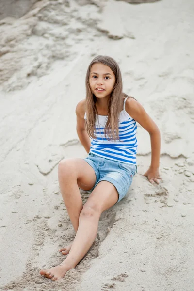 Girl in a striped vest on the sand — Stock Photo, Image