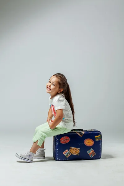 Girl on a suitcase — Stock Photo, Image