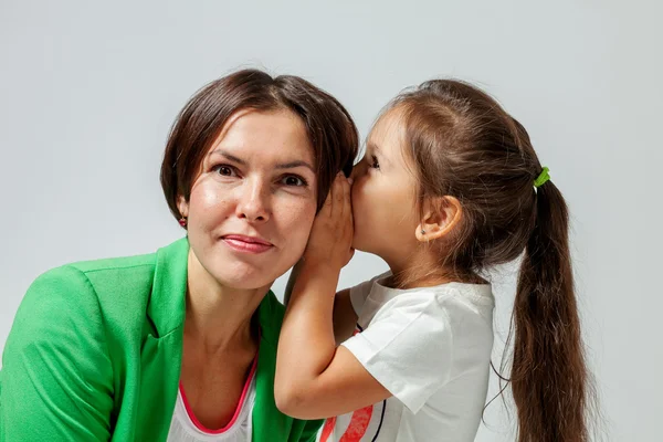 Daughter whispering to mother's ear — Stock Photo, Image