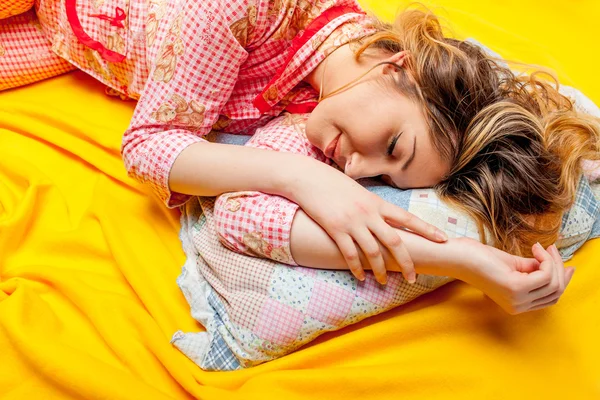 Girl sleeping on the yellow sheet — Stock Photo, Image