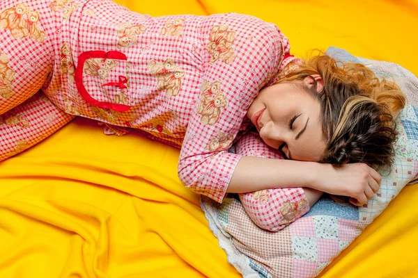 Girl sleeping on the yellow sheet — Stock Photo, Image