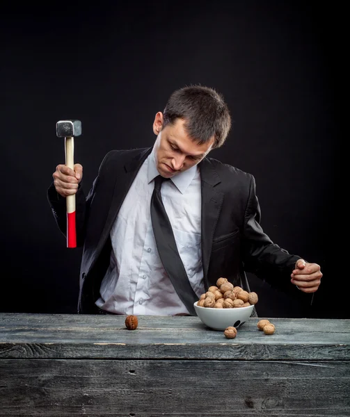 Young man stabs a nut — Stock Photo, Image