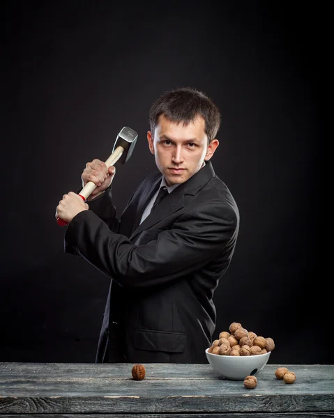Young man stabs a nut — Stock Photo, Image