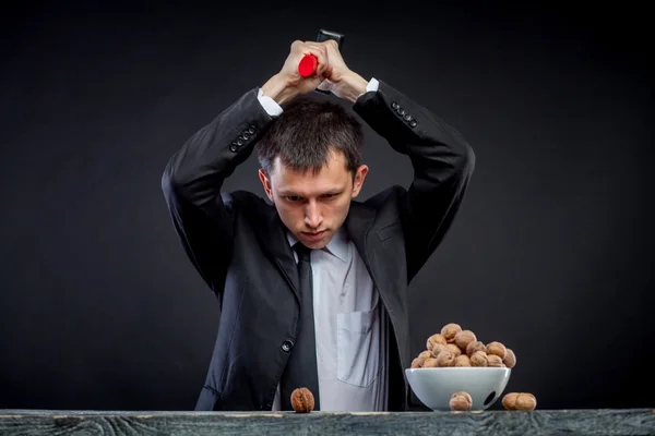 Young man stabs a nut — Stock Photo, Image