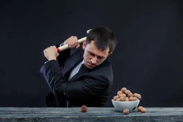 Young man stabs a nut — Stock Photo, Image