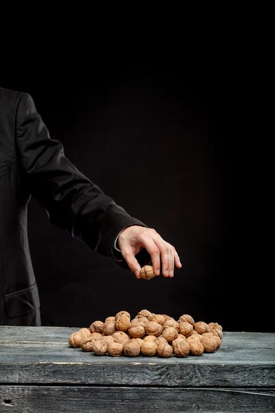 Young man stabs a nut — Stock Photo, Image