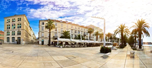 Split waterfront walkway on golden sun rays — Stock Photo, Image