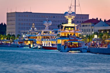 Luxury yachts on Split waterfront evening view clipart