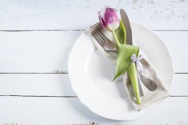 Table setting with spring flowers and cutlery.