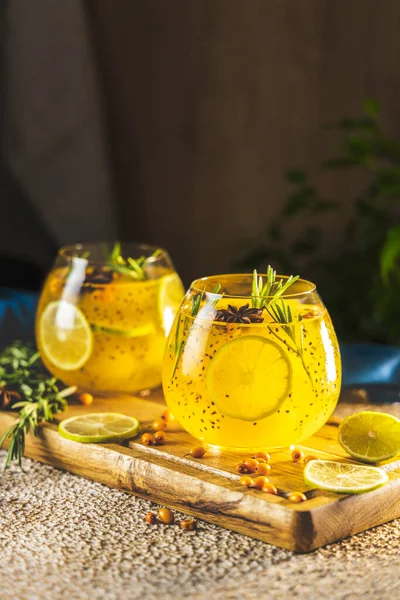 Homemade fruit tea with sea buckthorn, lime, rosemary, star anise and chia seeds for autumn and winter holidays - festive Christmas, Thanksgiving drinks.  Healthy food life.