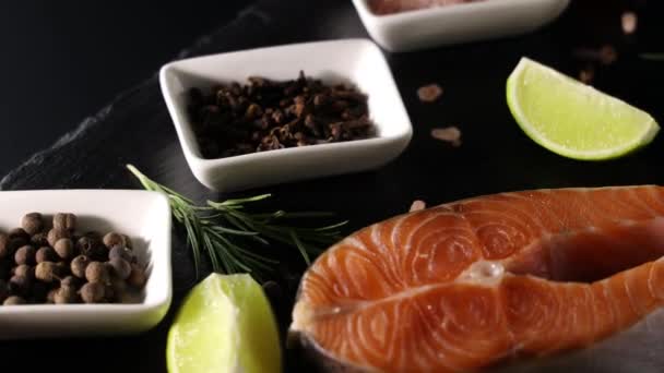 Raw Fresh Salmon Steak Slate Board Salt Peppers Lemon Cloves — Stock Video