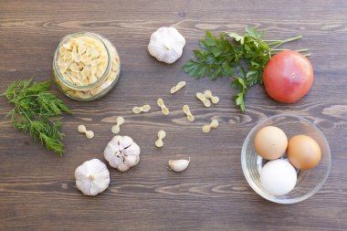 Makarna ve bir bardak taze sebze ve otlar ile taze yumurta.