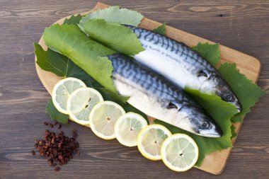 limon dilimleri ile taze uskumru üzüm yaprakları