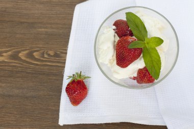 Ice cream strawberry in glass on board, selective focus