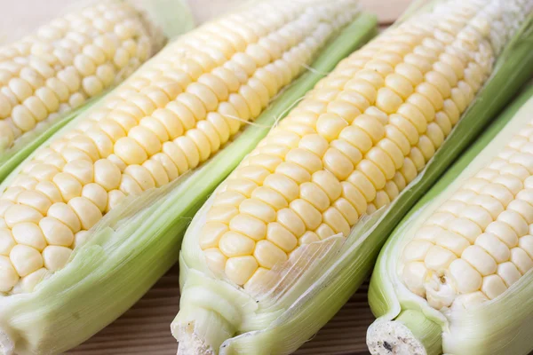 Fresh corn on the wooden table, selective focus