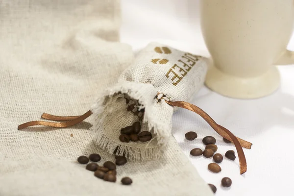 Sachet with embroidery stitch with coffee beans, selective focus