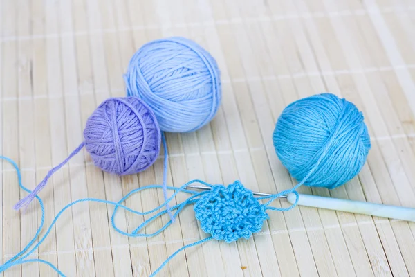 Colorful clews and crochet hook on wooden background — Stock Photo, Image