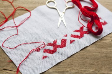 Ukrainian national red embroidery thread, selective focus