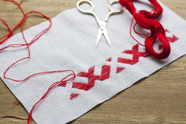 Ukrainian national red embroidery thread, selective focus