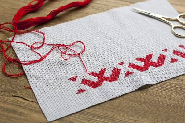 Ukrainian national red embroidery thread, selective focus