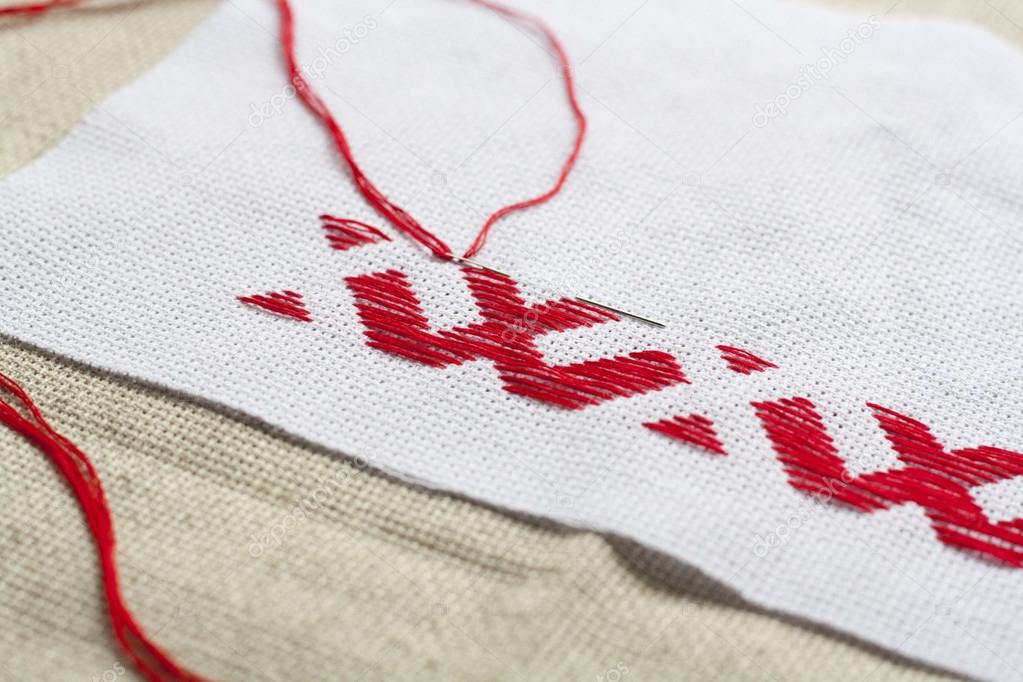 Ukrainian national red embroidery thread, selective focus