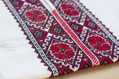 Shirt with national Ukrainian embroidered red and black colors, selective focus