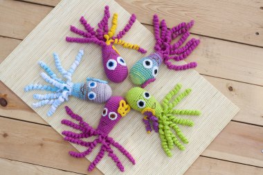 Crocheted woven with colored wool toy octopus close-up, selective focus
