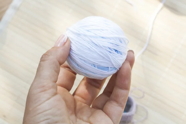 Color woolen clews for knitting in hand close-up, selective focus — 스톡 사진