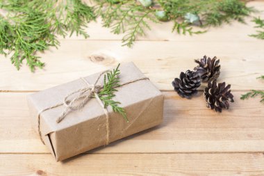 Christmas Gift, nuts, cones and green arborvitae branch on a wooden table