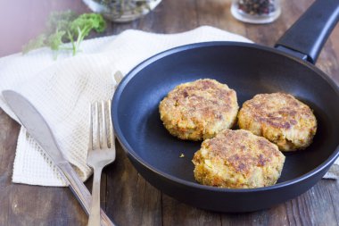 Burger (cutlet) In The Frying Pan. Burger (cutlet) in the frying pan on the wooden table