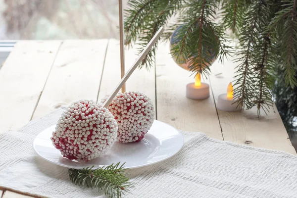 Apples in caramel with rice balls coating on Christmas and New Year background decor closeup — Stok fotoğraf