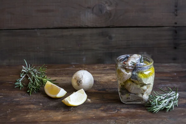 Preserved marinated sliced fish in a glass jar. — Stock Photo, Image