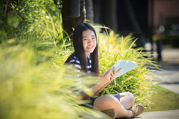 Asian girl and school book in hand toothy smiling face with happ — Stock Photo, Image