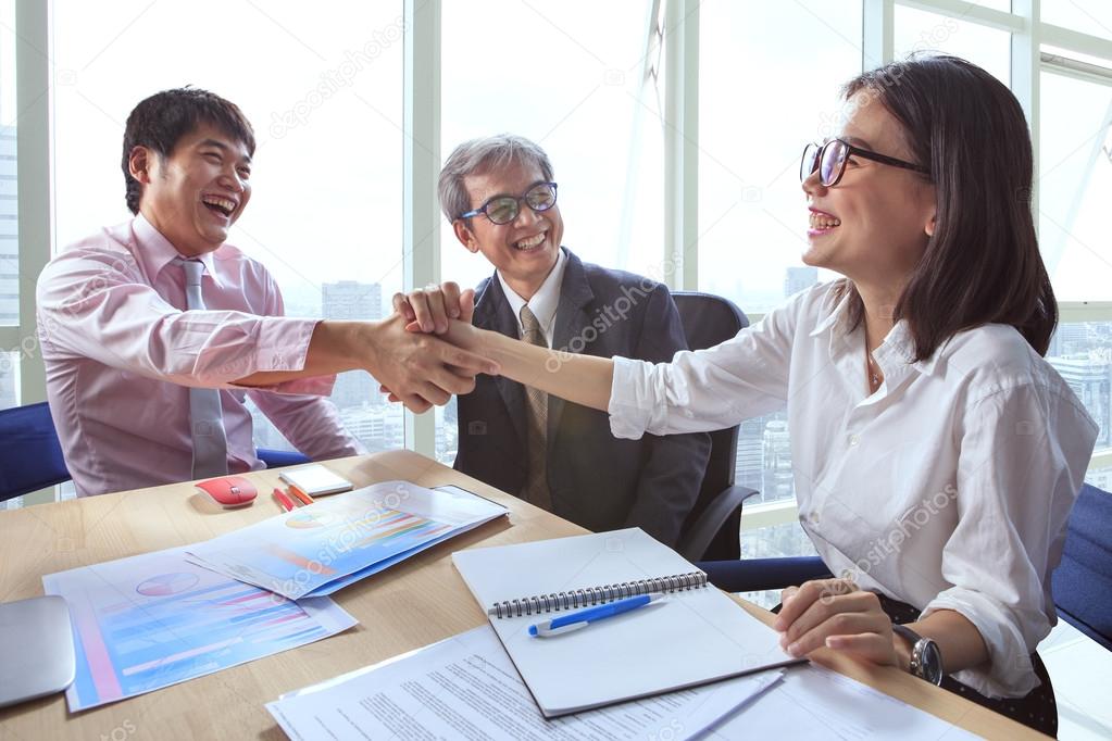 business team work shaking hand in office meeting room with happ