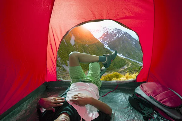 Camping man lying in outdoor camping tent with beautiful natural — Stock Photo, Image