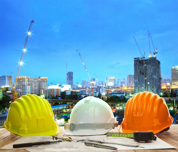 Engineer working table with hard hat plan and writing tool again — Stock Photo, Image