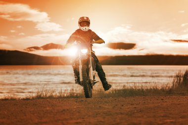 man riding enduro motorcycle in motor cross track use for people clipart