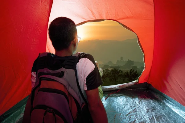 Camping man in tent and sun rising sky — Stock Photo, Image