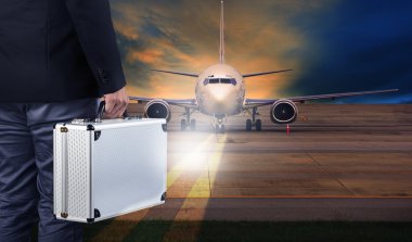 business man with metal strong luggage standing in airport runwa clipart