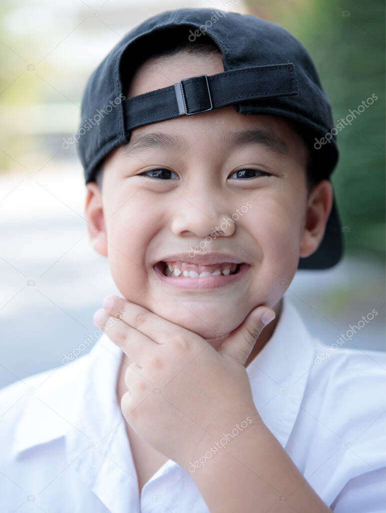 asian children toothy smiling face with happiness standing outdoor